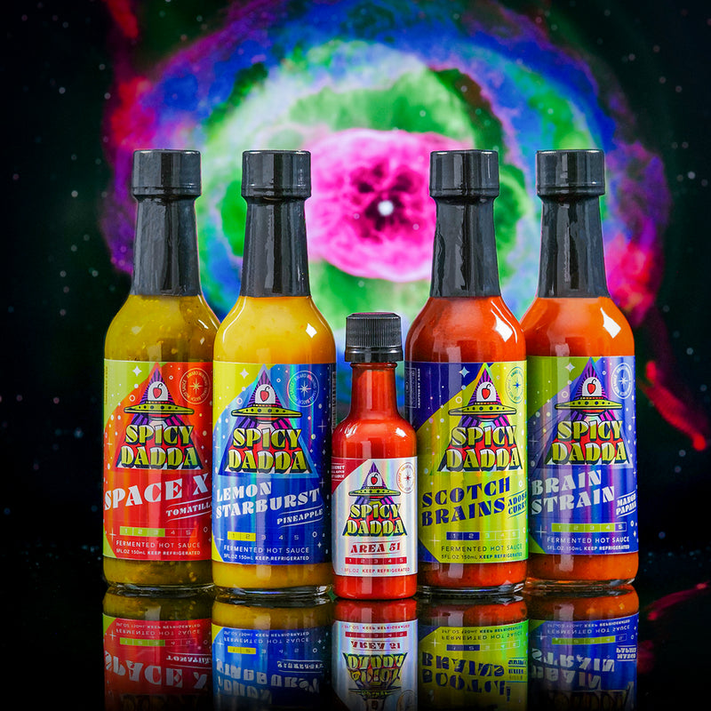 The Spicy Dadda First Contact bundle featuring our five signature flavors of homegrown fermented hot sauce against a surreal cosmic space background.